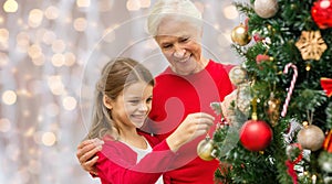 Grandmother and granddaughter at christmas tree