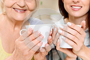 Grandmother and granddaughter with cups