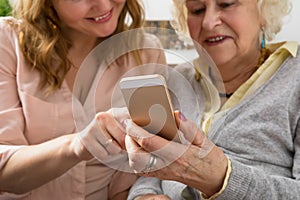 Grandmother and granddaughter exploring smartphone