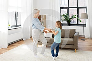 Grandmother and granddaughter having fun at home