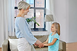 Grandmother and granddaughter holding hands