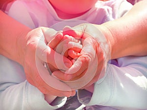 Grandmother and granddaughter holding hands together. Support, love and togetherness  people concept