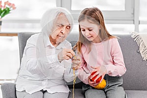 Grandmother and granddaughter knitting
