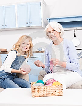 Grandmother and granddaughter knitting