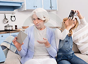 Grandmother and granddaughter making photos