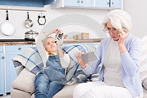 Grandmother and granddaughter making photos