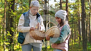 Grandmother and granddaughter picking mushrooms