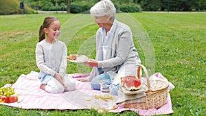 Grandmother and granddaughter at picnic in park