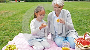 Grandmother and granddaughter at picnic in park