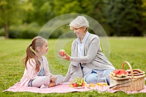 Grandmother and granddaughter at picnic in park