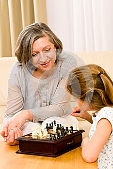 Grandmother and granddaughter play chess together