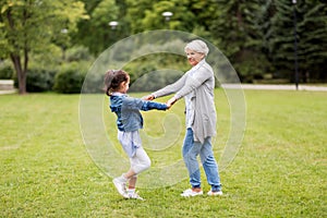 Grandmother and granddaughter playing at park