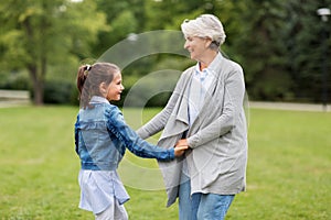 Grandmother and granddaughter playing at park