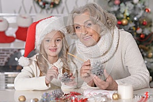 Grandmother and granddaughter preparing for Christmas