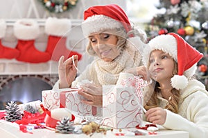 Grandmother and granddaughter preparing for Christmas