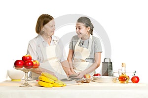 The grandmother and the granddaughter read the recipe-book