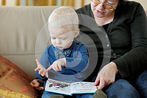 Grandmother and granddaughter reading a book