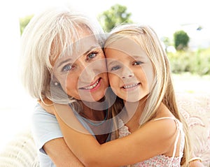 Grandmother With Granddaughter Relaxing Together