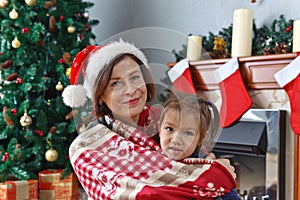 grandmother and granddaughter in the room with Christmas decorations