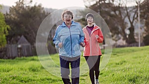 Grandmother and granddaughter running together. Slow motion. International Day of Older Persons. The concept of a