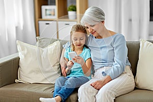 Grandmother and granddaughter with smartphone