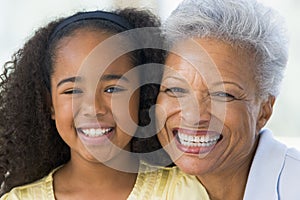 Grandmother and granddaughter smiling