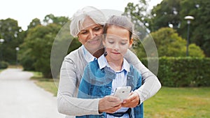 Grandmother and granddaughter take selfie at park