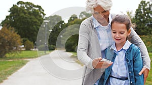 Grandmother and granddaughter take selfie at park