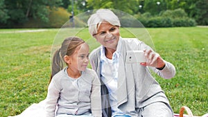 Grandmother and granddaughter take selfie at park