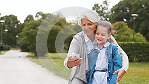 Grandmother and granddaughter take selfie at park