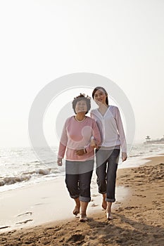 Grandmother and Granddaughter Taking a Walk by the Beach, Smiling