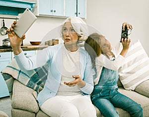 Grandmother And Granddaughter Trying To Make Photos With Unusual Gadgets