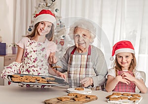 Grandmother with granddaughters baking cookies