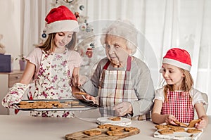 Grandmother with granddaughters baking cookies