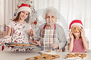 Grandmother with granddaughters baking cookies