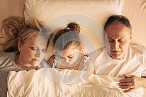 Grandmother and grandfather sleeping together in bed.