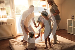 Grandmother and grandfather together with their granddaughters