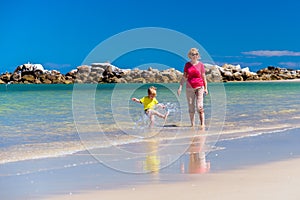 Grandmother with grandson on the beach