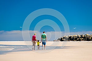 Grandmother with grandson on the beach