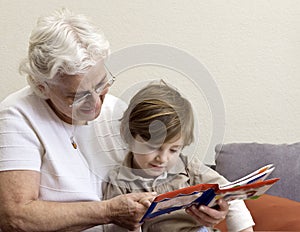 Grandmother and grandson reading book