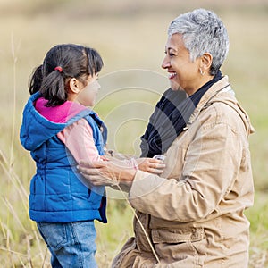 Grandmother, happy girl and family love of a kid with senior woman in the countryside. Outdoor field, grass and elderly