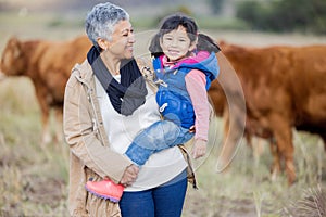 Grandmother, happy girl portrait and nature with cows and senior woman in the countryside. Outdoor field, hug and