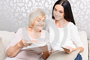 Grandmother with her daughter holding book