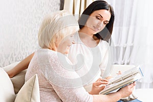 Grandmother with her daughter holding book