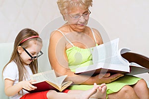 Grandmother and her granddaughter are reading