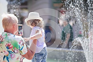 Grandmother and her granddaughter walking in the city, taking time together.