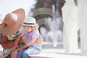 Grandmother and her granddaughter walking in the city, taking time together.