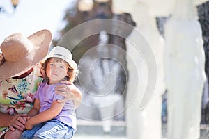 Grandmother and her granddaughter walking in the city, taking time together.