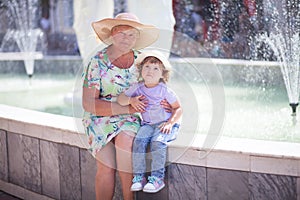 Grandmother and her granddaughter walking in the city, taking time together.