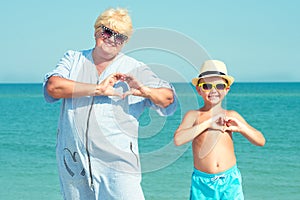 Grandmother with her grandson are resting on the sea.Love to the sea.